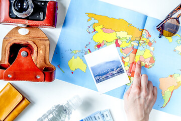 tourist lifestyle with camera and map white table background top view