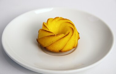 Salty muffin with cheese and corn flour on white plates