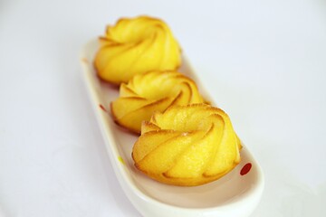 Salty muffin with cheese and corn flour on white plates