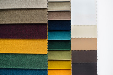 Catalog of fabrics to choose by texture and color for a new sofa, chairs in the living room, close-up