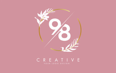 Number 98 9 8 logo design with golden circle and white leaves on branches around.