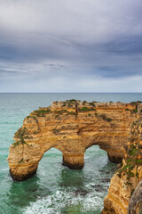 Landscape on the Algarve coast at sunset. Beach in southern Portugal the best travel destination for tourists on vacation. seascape with caves through the cliffs