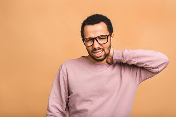 Black african american man isolated on beige background guy feels physical discomfort unhealthy tired closed his eyes for neck pain massaging tensed muscles relieve joint shoulder ache concept