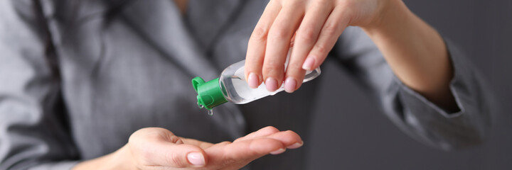 Woman applies hand sanitizer. Hand treatment from viruses