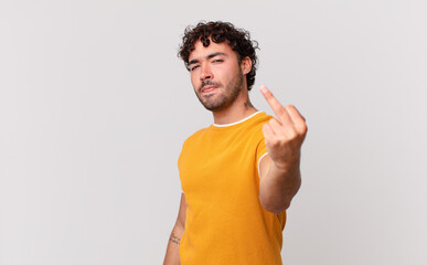 hispanic handsome man feeling angry, annoyed, rebellious and aggressive, flipping the middle...