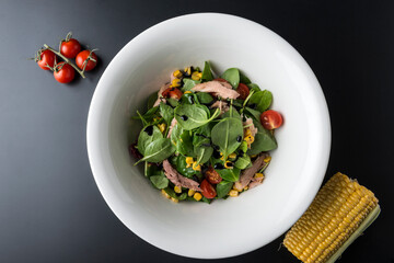 Tuna Salad in white bowl on wooden table
