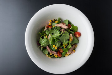 Tuna Salad in white bowl on wooden table
