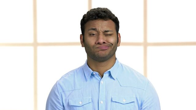 Indian man making funny faces close up.