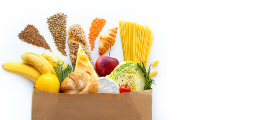 Paper bag with healthy food.Vegetarian food.Healthy food background.Supermarket food concept.Asparagus, cheese,  fruits, vegetables, avocados and mushrooms.Shopping at the supermarket.Home delivery