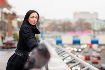 Portrait of a woman standing in an open area on the street