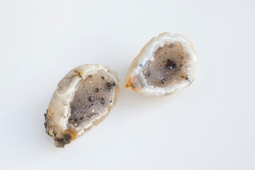 Druse of natural mineral agate. Closeup photo. Couple of beige crystals with black small inclusions.