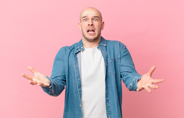 bald man open-mouthed and amazed, shocked and astonished with an unbelievable surprise