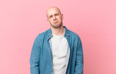 bald man feeling sad and whiney with an unhappy look, crying with a negative and frustrated attitude