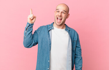 bald man feeling like a happy and excited genius after realizing an idea, cheerfully raising...
