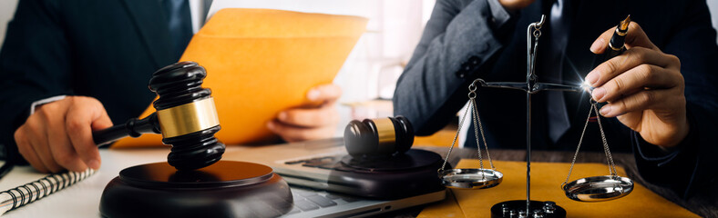 Business and lawyers discussing contract papers with brass scale on desk in office. Law, legal services, advice, justice and law concept picture with film grain effect
