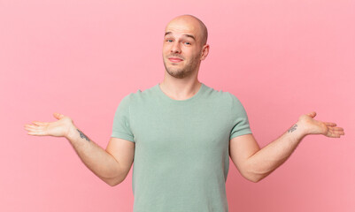 bald man feeling puzzled and confused, doubting, weighting or choosing different options with funny...