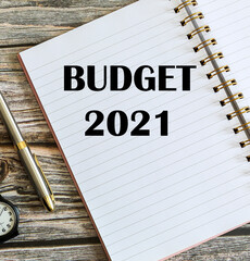 Top view of a pen with Budget 2021 written on a notebook.