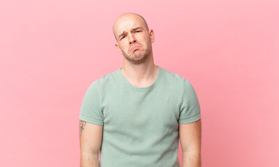 bald man feeling sad and whiney with an unhappy look, crying with a negative and frustrated attitude