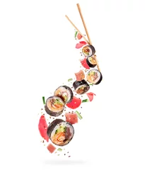Deurstickers Fresh sushi rolls with various ingredients in the air on white background © Krafla
