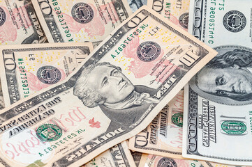 Close-up money in denominations 100, 20 and 10 US dollars, exchange currency cash, business investment, background from banknotes.