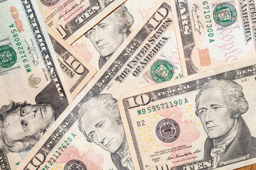 Close-up banknotes of 20 and 10 US dollars, top view. Cash exchange currency, business investment, background from banknotes.