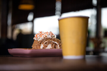 dessert and a cup of coffee on a wooden table in a cafe