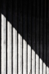 Background with lines on the concrete wall by shadows 