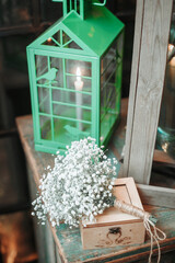 wooden box for wedding rings next to the lantern