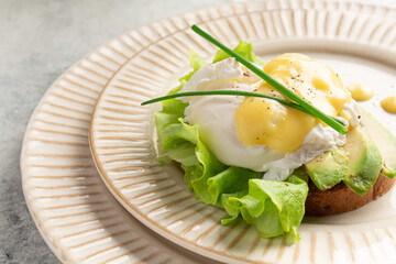 egg benedict on a plate, plating, close-up