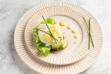 egg benedict on a plate, plating, close-up