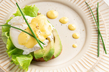 egg benedict on a plate, plating, close-up