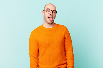 bald man with cheerful, carefree, rebellious attitude, joking and sticking tongue out, having fun
