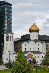 Fototapeta na wymiar Nikolskaya Old Believers Church against the background of a modern business center in Moscow