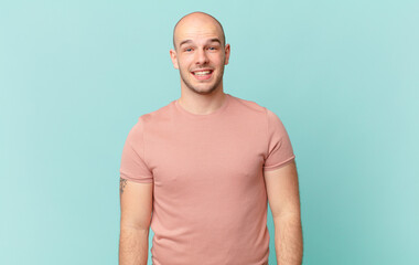 bald man looking happy and pleasantly surprised, excited with a fascinated and shocked expression