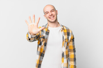 bald man smiling and looking friendly, showing number five or fifth with hand forward, counting down