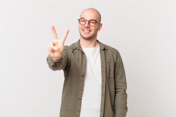 bald man smiling and looking friendly, showing number two or second with hand forward, counting down