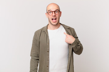 bald man looking shocked and surprised with mouth wide open, pointing to self