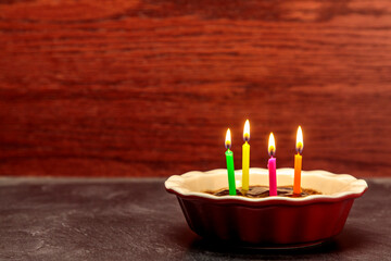 Obraz na płótnie Canvas Four Candles on a Small Cake