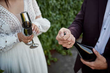 Couple toasting wine glasses for celebration. Two people holding flutes doing cheers