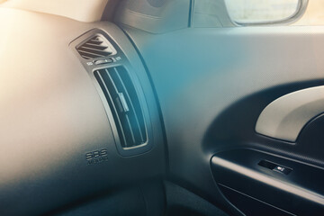 Air ventiation grille in car interior. Cold air flowing from car air conditioning system. Detail interrion of the car.