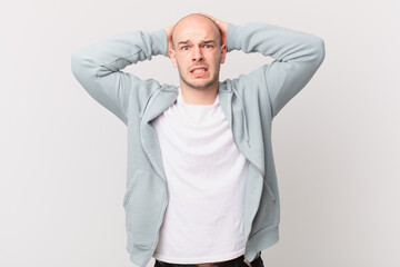 bald man feeling stressed, worried, anxious or scared, with hands on head, panicking at mistake