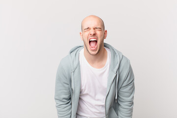 bald man shouting aggressively, looking very angry, frustrated, outraged or annoyed, screaming no