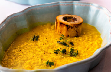 Yellow risotto alla milanese with saffron and bone marrow on a plate