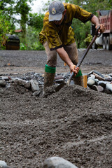 Workers on the field. Moving dirt to make gardens. 