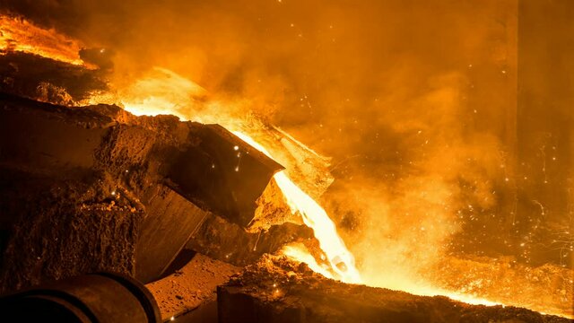 Tank pours liquid metal in the molds at the steel mill. Cinemagraph.