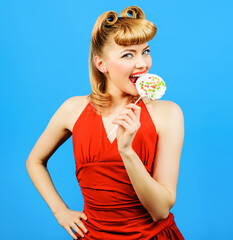 Sexy girl with fashion hairstyle eating lollipop. Beautiful woman with candy.