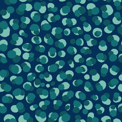 Doodled dots seamless repeat pattern. Overlapped vector abstract circle elements all over print on green background.