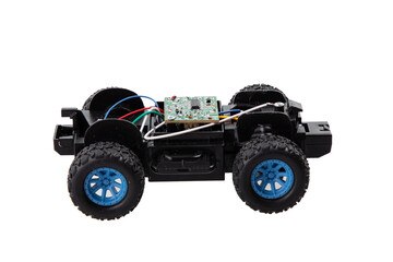 Broken radio-controlled toy car with electronic components on a white background 