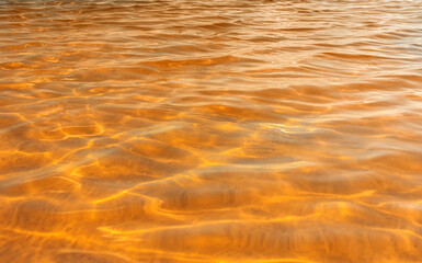water texture with waves. sea waves with sun glare.
