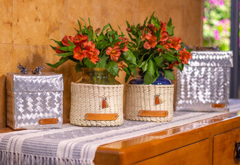 baskets and pots made of palm leaves and aluminum in the living room of the house. Handmade and traditional product from Mexico